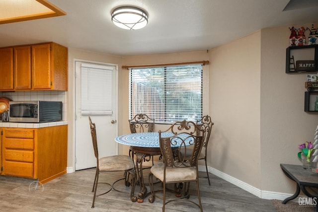 dining space with light hardwood / wood-style floors