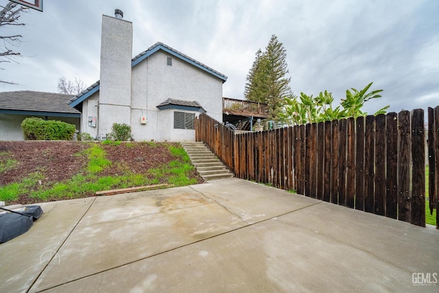 view of side of property featuring a patio area