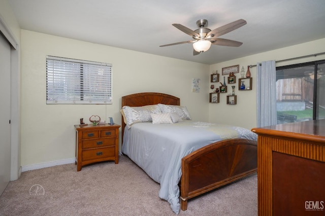 carpeted bedroom with ceiling fan and a closet