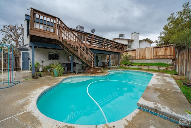 view of pool with a deck, a patio, and central air condition unit