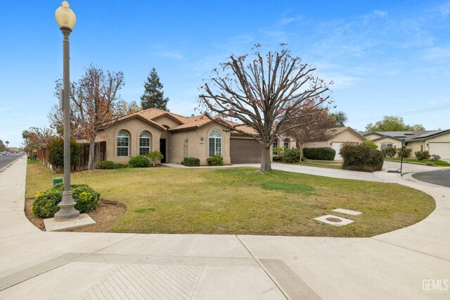 7303 Glenn Miller Ct, Bakersfield, CA 93312 - mediterranean / spanish home with a front yard, a tiled roof, fence, stucco siding, and driveway