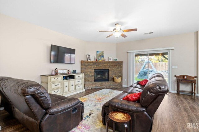 7303 Glenn Miller Ct, Bakersfield, CA 93312 - living room featuring a fireplace, a ceiling fan, visible vents, wood finished floors, and baseboards
