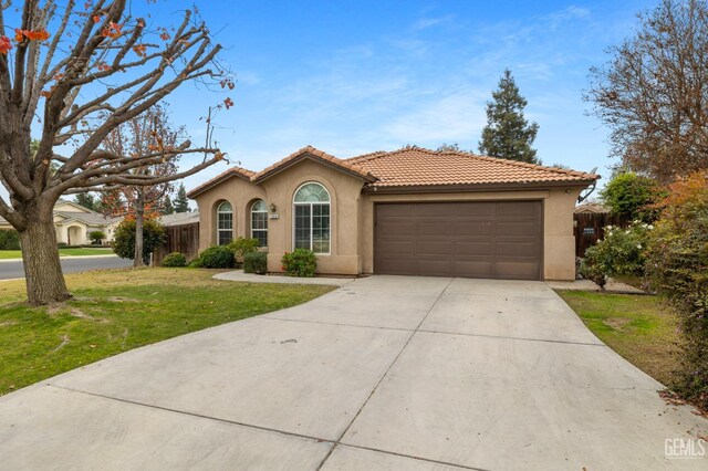 7303 Glenn Miller Ct, Bakersfield, CA 93312 - mediterranean / spanish home with a tiled roof, stucco siding, a front yard, a garage, and concrete driveway