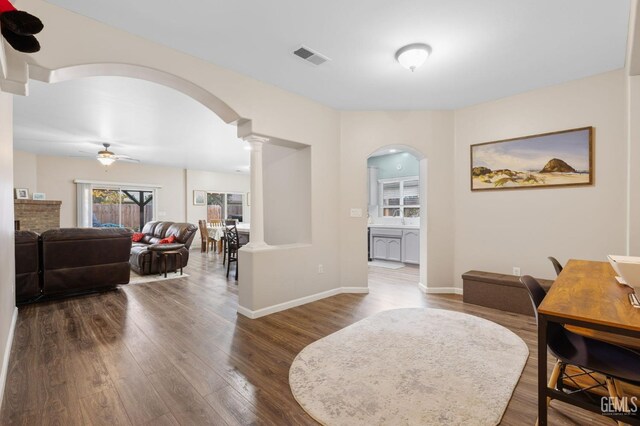 7303 Glenn Miller Ct, Bakersfield, CA 93312 - dining room with decorative columns, arched walkways, dark wood-type flooring, and ceiling fan