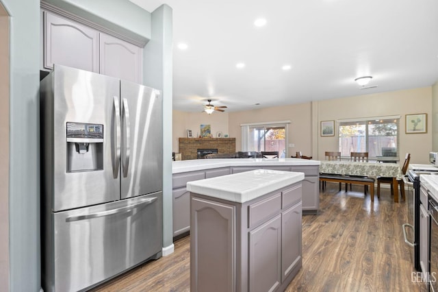 7303 Glenn Miller Ct, Bakersfield, CA 93312 - kitchen with stainless steel refrigerator with ice dispenser, a ceiling fan, a peninsula, gray cabinets, and tile countertops