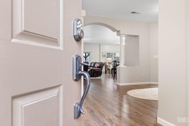 7303 Glenn Miller Ct, Bakersfield, CA 93312 - entryway featuring visible vents, baseboards, arched walkways, decorative columns, and wood finished floors