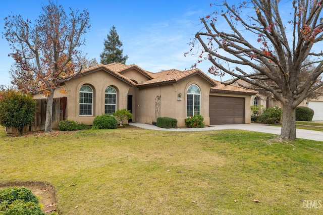 7303 Glenn Miller Ct, Bakersfield, CA 93312 - mediterranean / spanish house featuring a tiled roof, an attached garage, fence, stucco siding, and driveway