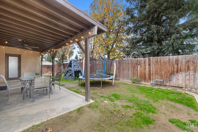 7303 Glenn Miller Ct, Bakersfield, CA 93312 - view of yard with a trampoline, a patio area, and a fenced backyard