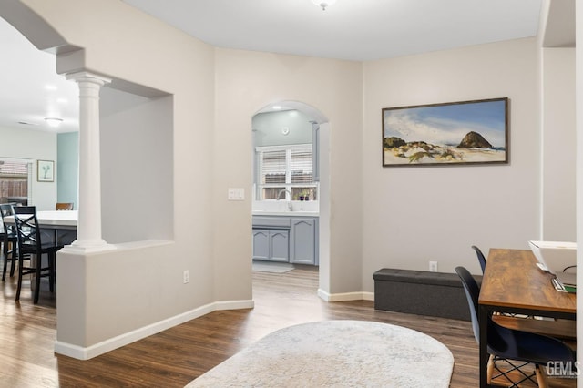7303 Glenn Miller Ct, Bakersfield, CA 93312 - office space featuring baseboards, arched walkways, a sink, ornate columns, and wood finished floors