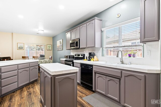 7303 Glenn Miller Ct, Bakersfield, CA 93312 - kitchen with tile counters, appliances with stainless steel finishes, a sink, gray cabinetry, and backsplash