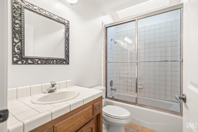 7205 Bandolero Way, Bakersfield, CA 93308 - full bath featuring toilet, vanity, bath / shower combo with glass door, and tile patterned flooring