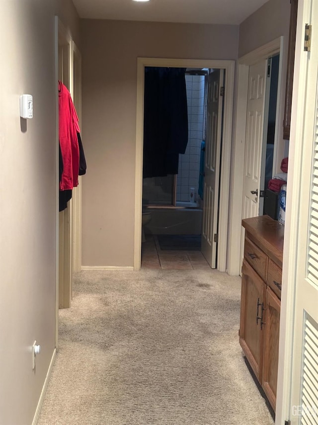 hallway with light colored carpet