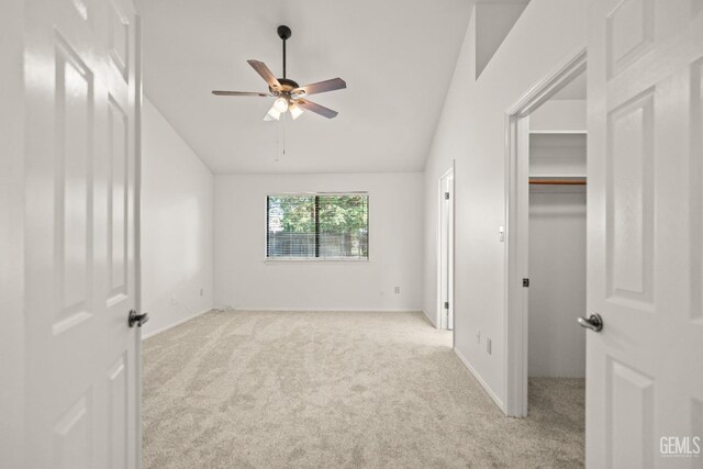 7205 Bandolero Way, Bakersfield, CA 93308 - unfurnished bedroom featuring light colored carpet, a walk in closet, lofted ceiling, and baseboards