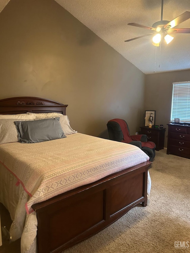 carpeted bedroom featuring ceiling fan, lofted ceiling, and a textured ceiling