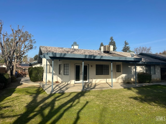 rear view of house featuring central AC, a yard, and a patio