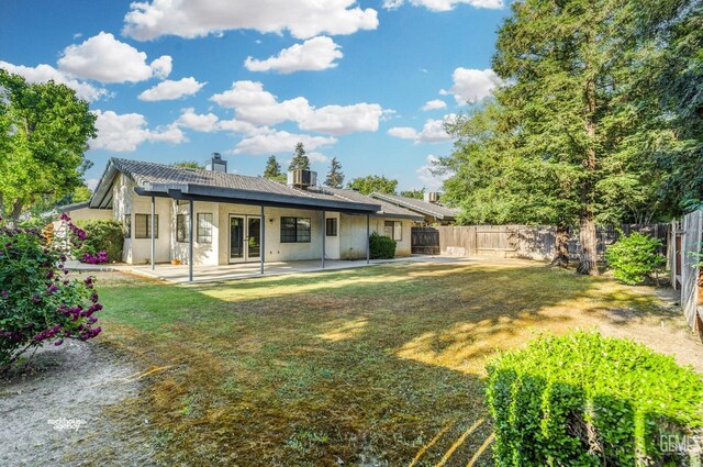 7205 Bandolero Way, Bakersfield, CA 93308 - back of property featuring a chimney, a patio area, and french doors