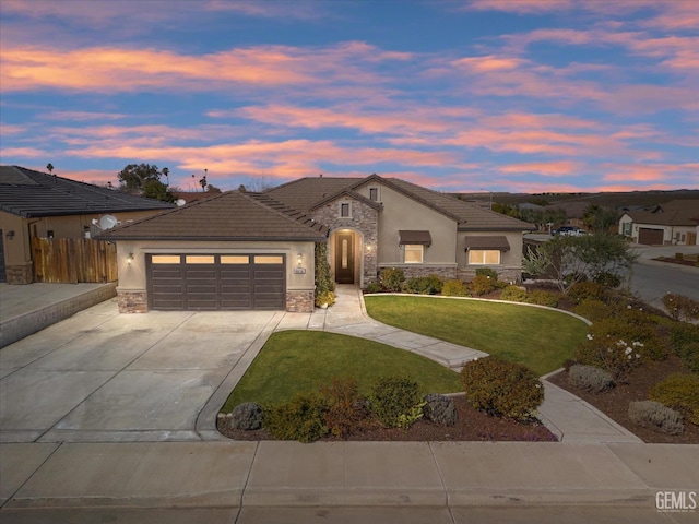 view of front of house featuring a garage and a lawn