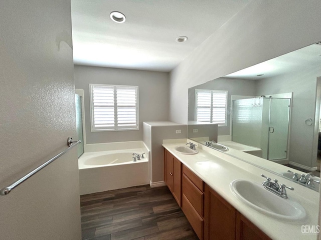 10315 Paradiso Way, Bakersfield, CA 93306 - bathroom with a bath, wood finished floors, a shower stall, double vanity, and recessed lighting