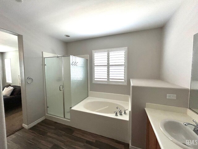 10315 Paradiso Way, Bakersfield, CA 93306 - bathroom with wood finished floors, a garden tub, a stall shower, and vanity