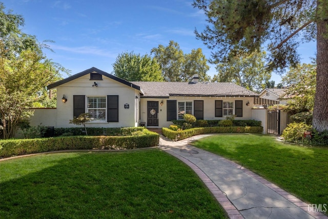 ranch-style home with a front lawn