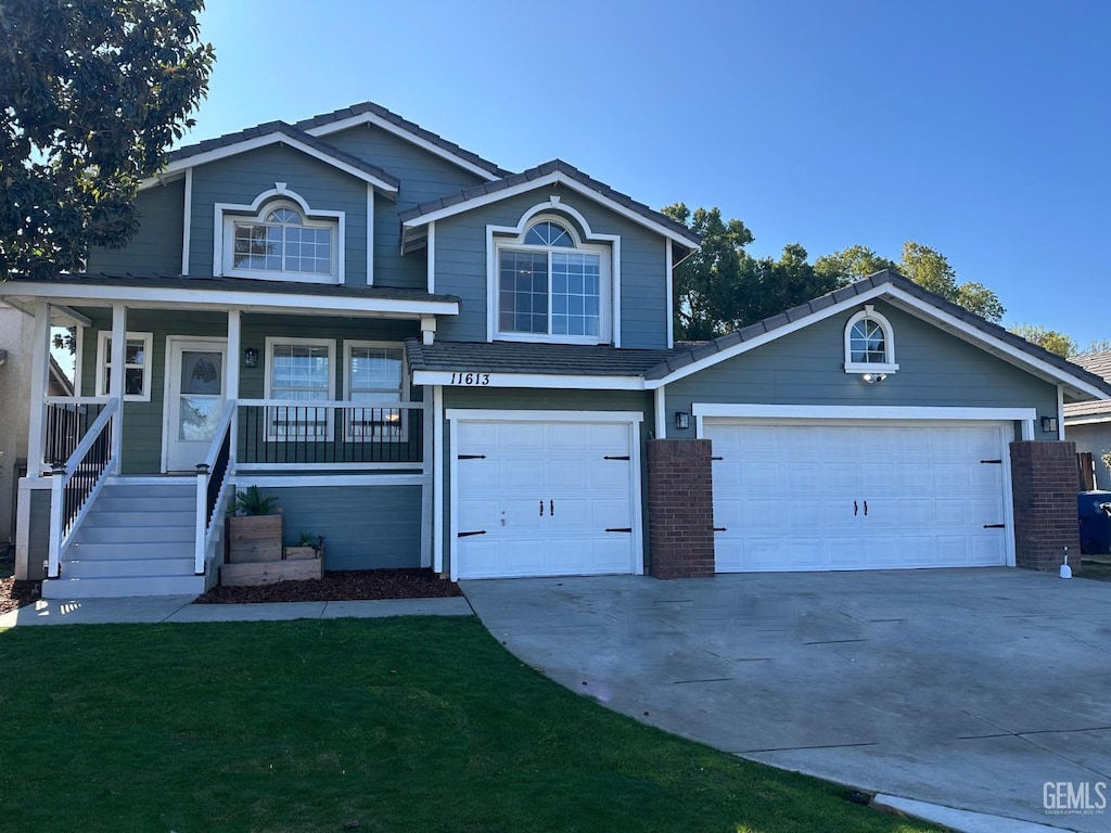 view of property featuring covered porch and a front lawn