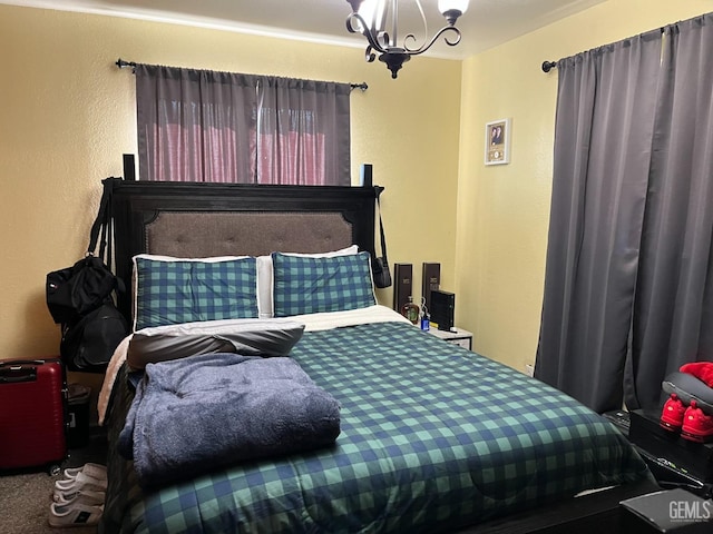 carpeted bedroom with a notable chandelier