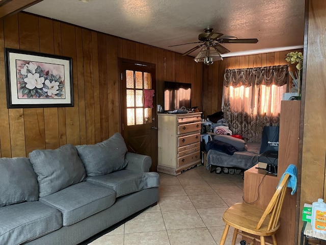 267 Cedar Ave, Earlimart, CA 93219 - living area featuring wooden walls, ceiling fan, a healthy amount of sunlight, and light tile patterned floors
