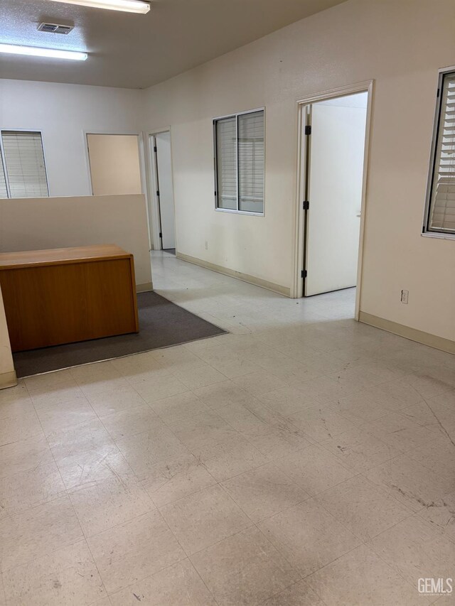 267 Cedar Ave, Earlimart, CA 93219 - empty room with visible vents, baseboards, and tile patterned floors