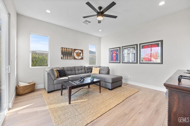 living room with ceiling fan and light hardwood / wood-style floors