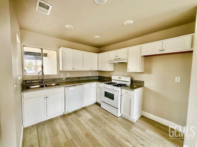 kitchen featuring sink, white appliances, white cabinets, and light wood-type flooring