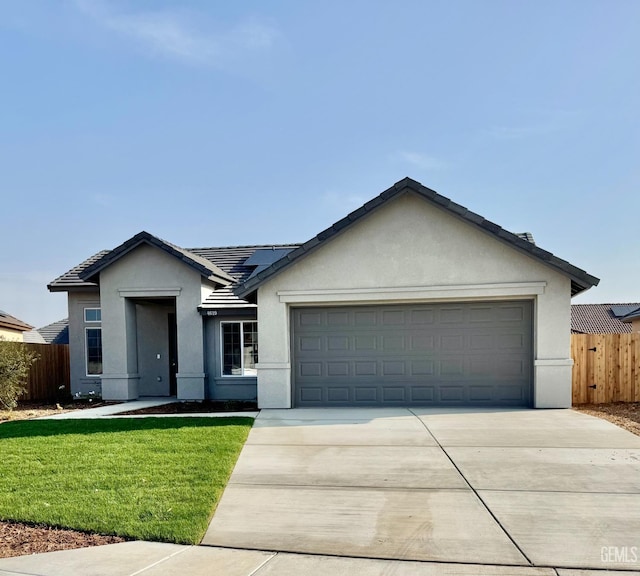 ranch-style home featuring a garage and a front yard