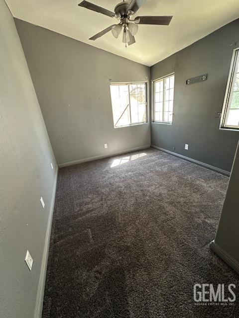 9306 Vista Colina Dr, Bakersfield, CA 93306 - spare room with lofted ceiling, plenty of natural light, a ceiling fan, and carpet flooring