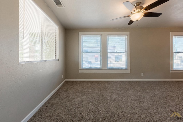 unfurnished room with carpet flooring, ceiling fan, and a wealth of natural light