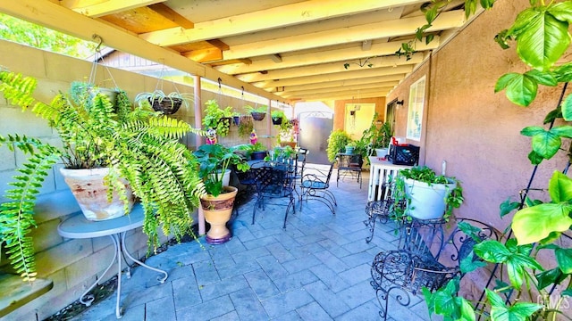 view of patio featuring outdoor dining area and fence