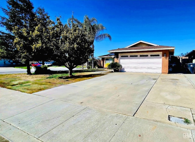 view of front of property with a garage and concrete driveway