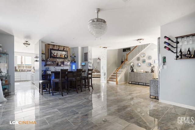 11703 Revolution Rd, Bakersfield, CA 93312 - dining area featuring stairs, a dry bar, and marble finish floors
