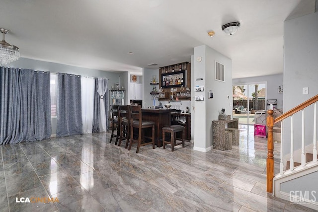 11703 Revolution Rd, Bakersfield, CA 93312 - dining room with a bar, marble tiled floors, and stairway