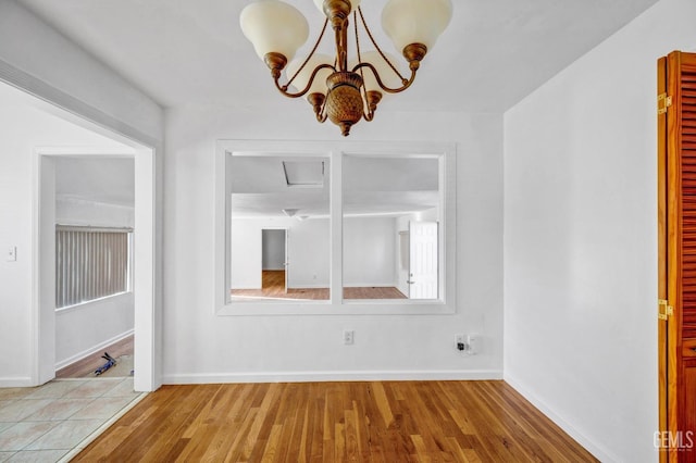 interior space with hardwood / wood-style flooring and an inviting chandelier