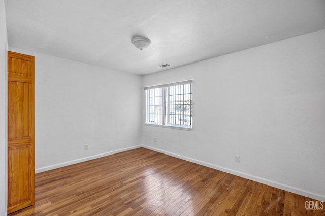 spare room featuring hardwood / wood-style flooring