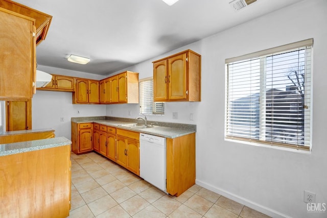 kitchen with plenty of natural light, light tile patterned floors, dishwasher, and sink