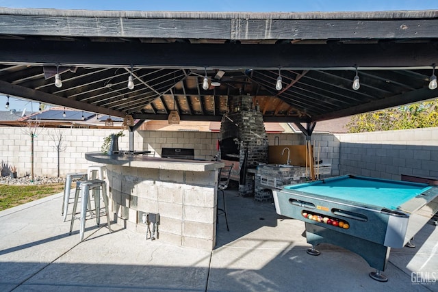 view of patio featuring a bar and a gazebo