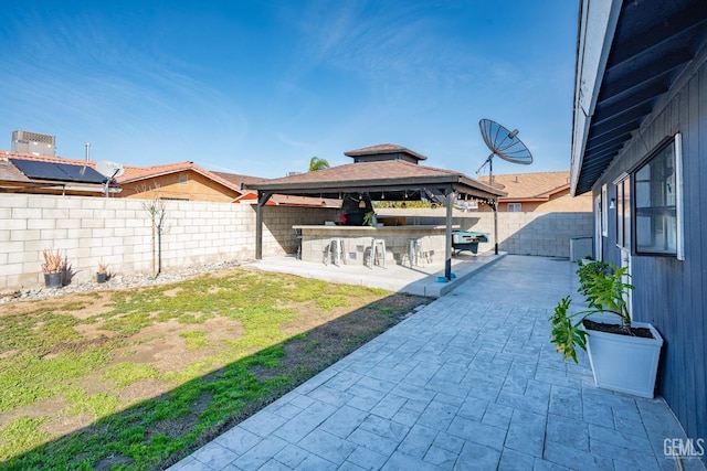 view of yard with a bar, a gazebo, and a patio area