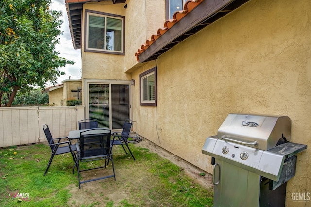 exterior space featuring area for grilling and fence