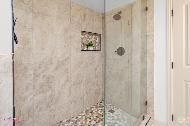 bathroom with tiled shower