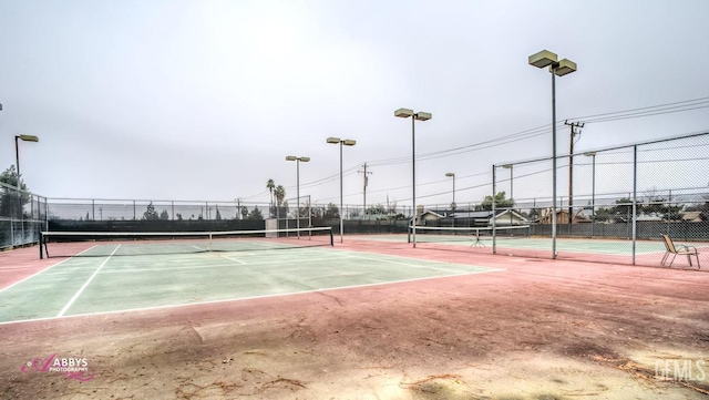 view of tennis court with fence