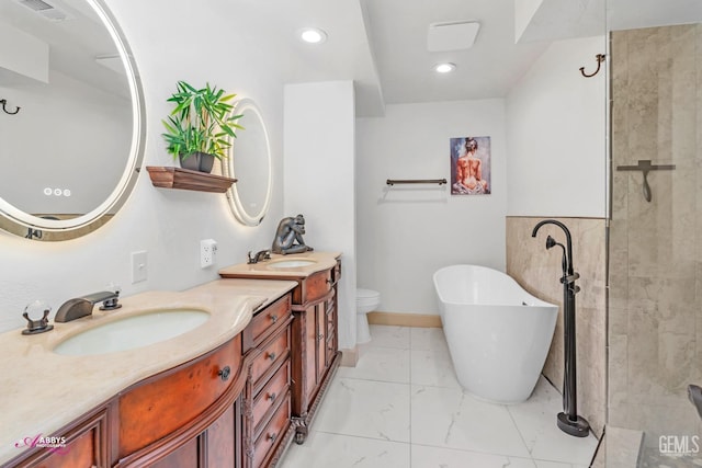 full bathroom featuring a sink, visible vents, a freestanding bath, marble finish floor, and double vanity