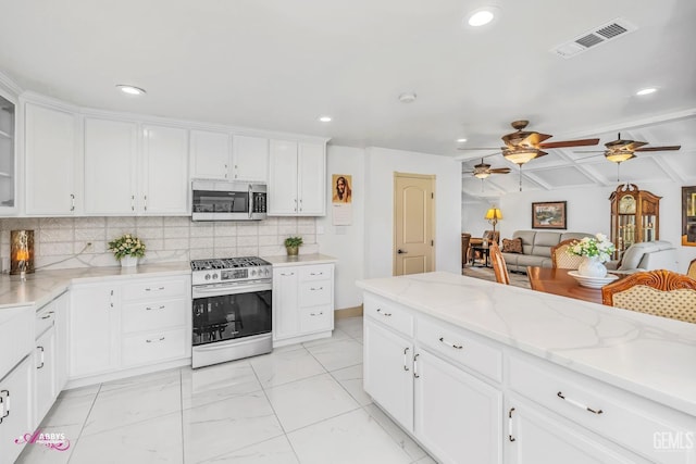 kitchen with stainless steel appliances, tasteful backsplash, visible vents, glass insert cabinets, and white cabinets