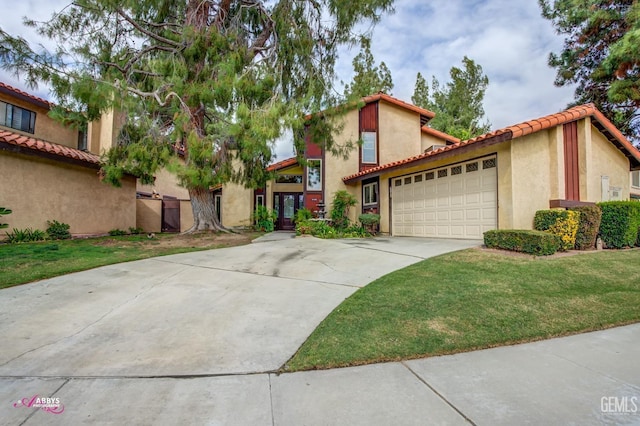 mediterranean / spanish-style house with stucco siding, an attached garage, a front yard, driveway, and a tiled roof