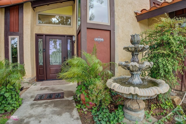 doorway to property with stucco siding