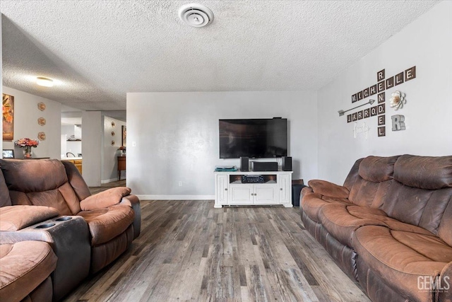 living room featuring hardwood / wood-style floors and a textured ceiling